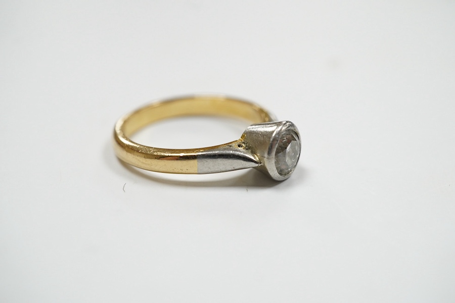 A yellow metal and collet set solitaire diamond set ring, size J/K, gross weight 4.2 grams. Condition - fair